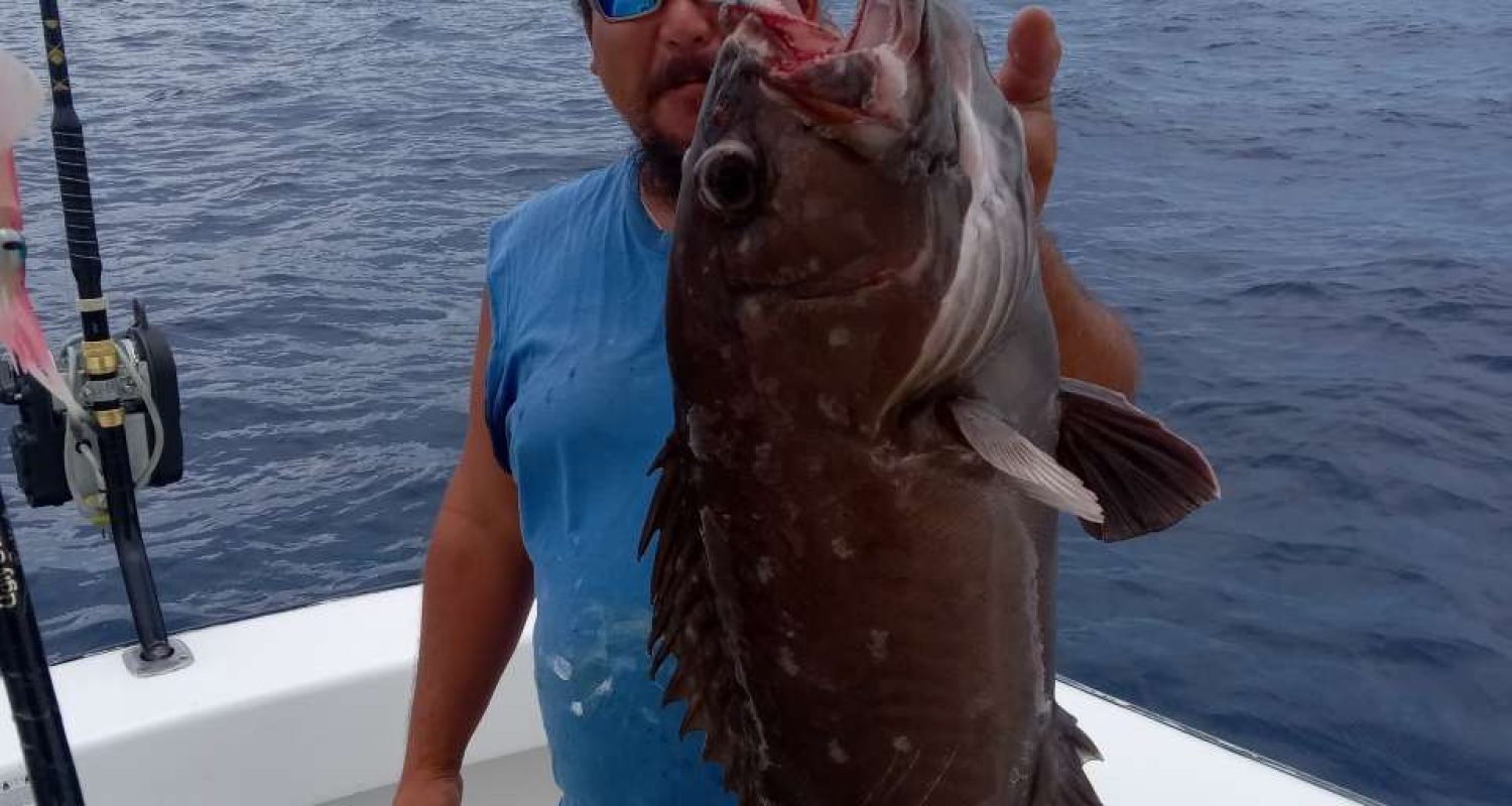 Man Holding A Large Fish | Floridafishing.Net